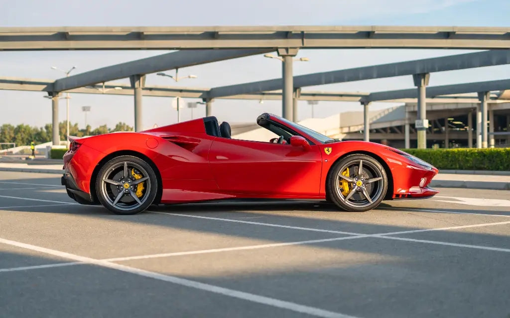 Rear angle view of a Ferrari F8 Tributo Spyder highlighting its powerful exhaust and taillights - Dubai exotic car rentals.
