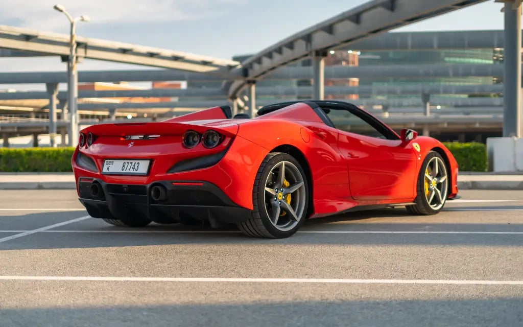 Side profile of a Ferrari F8 Tributo Spyder under city lights, perfect for cruising in Dubai - Sports car hire.