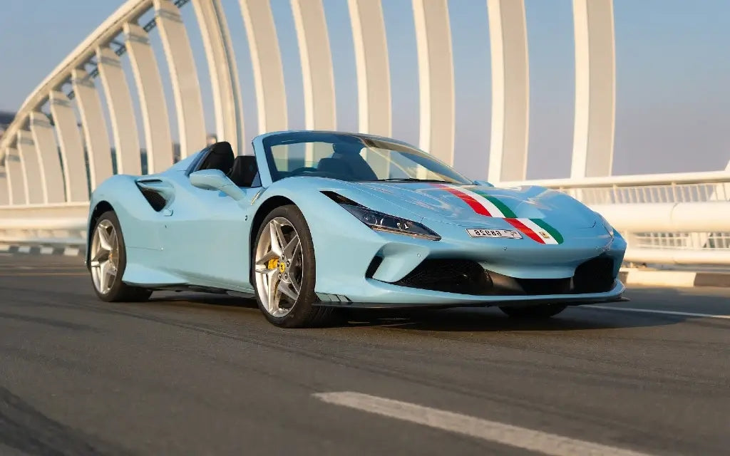 Ferrari F8 Tributo Spyder gleaming under Dubai's sun, perfect for luxury sports car rentals.
