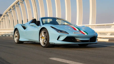 Ferrari F8 Tributo Spyder gleaming under Dubai's sun, perfect for luxury sports car rentals.