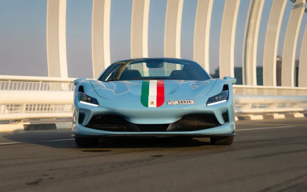 Side view of a sleek Ferrari F8 Tributo Spyder, available for rent in Dubai, showcasing its aerodynamic design.