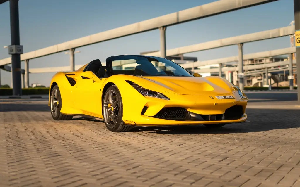 Ferrari F8 Tributo Spyder gleaming under the Dubai sun, perfect for high-end car rental enthusiasts.