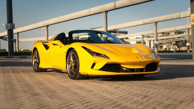 Ferrari F8 Tributo Spyder gleaming under the Dubai sun, perfect for high-end car rental enthusiasts.