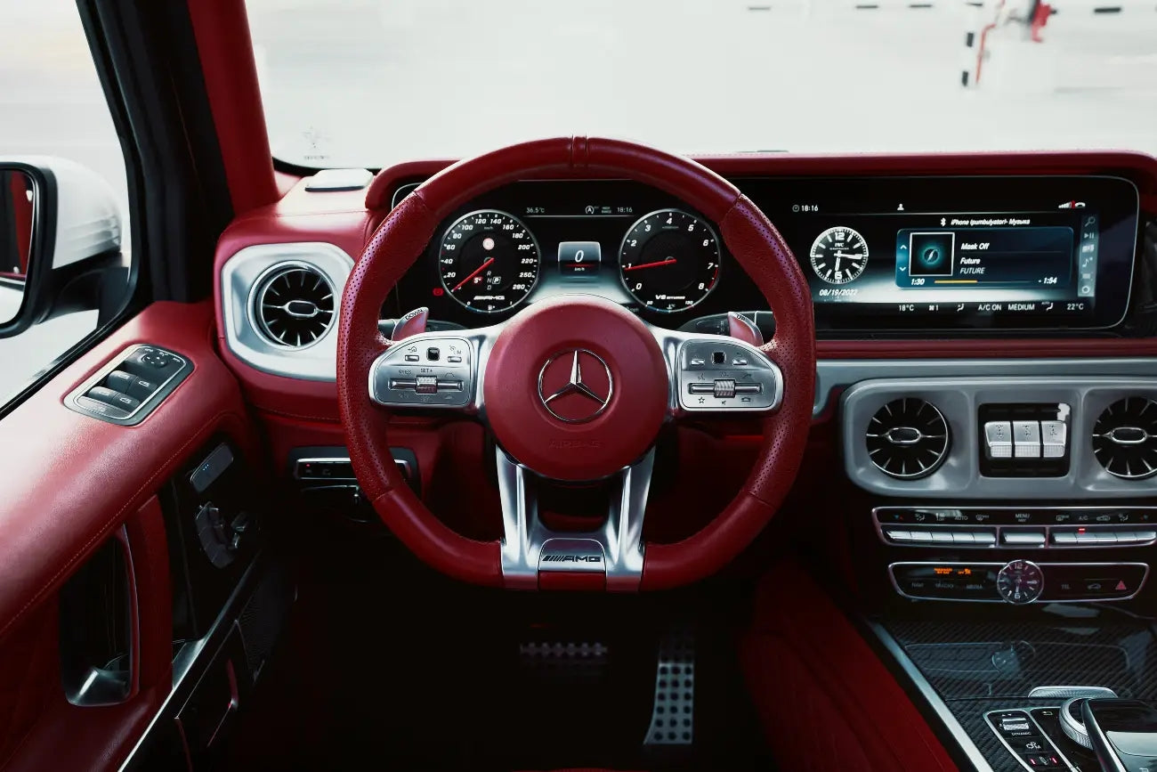 Rear view of a Mercedes Benz G63 luxury SUV rental in Dubai, showcasing its distinctive taillights and spacious cargo area.