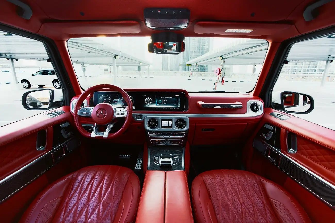 Close-up of the Mercedes Benz G63's dashboard and steering wheel in Dubai, offering a glimpse into its luxury rental experience.