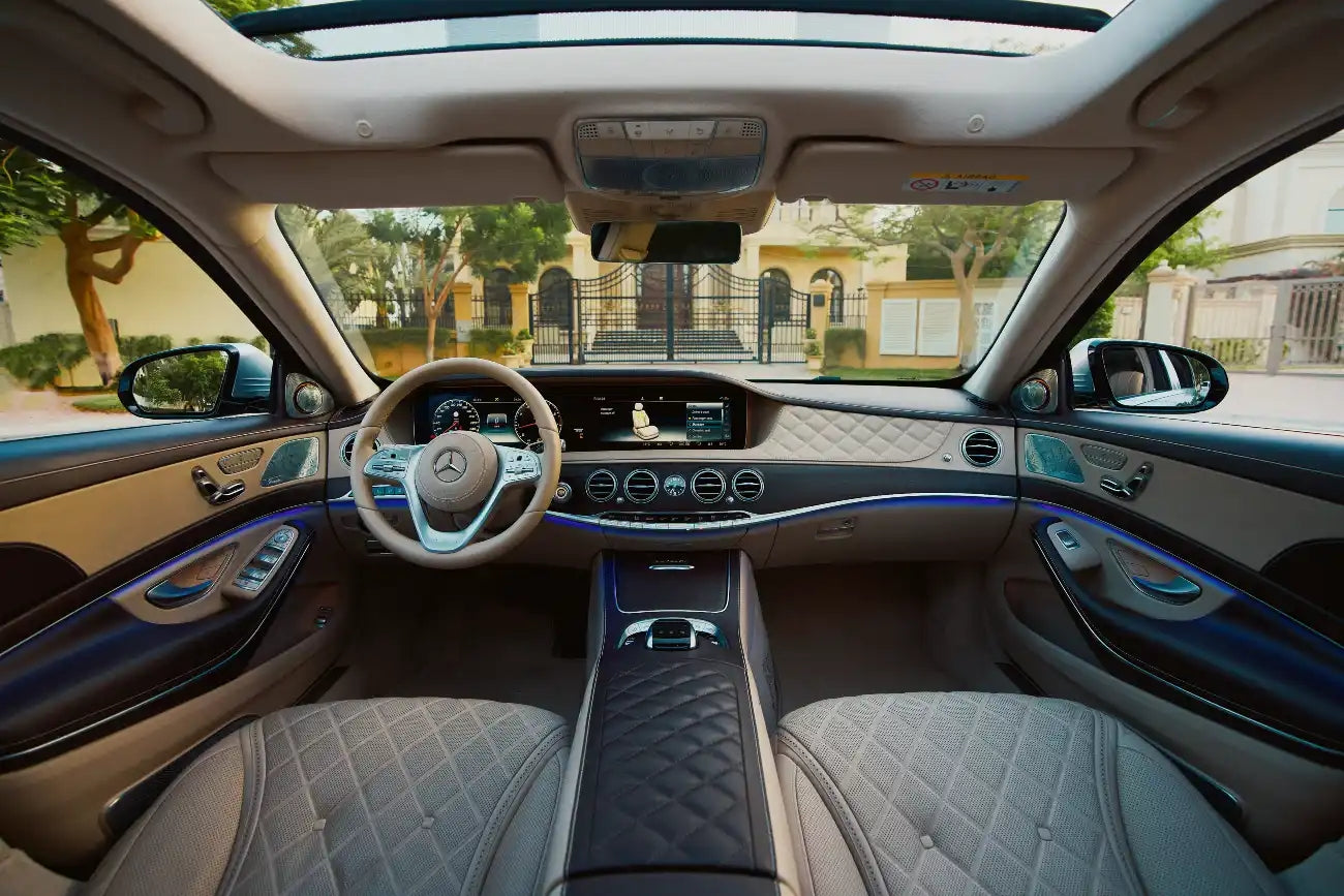 Mercedes Benz Maybach S650 gleaming under Dubai's skyline, epitomizing luxury car rental elegance.