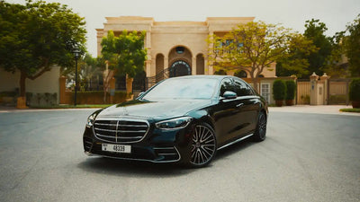 Elegant silver 2021 Mercedes-Benz S500 parked with Dubai skyline in the background - luxury sedan rental