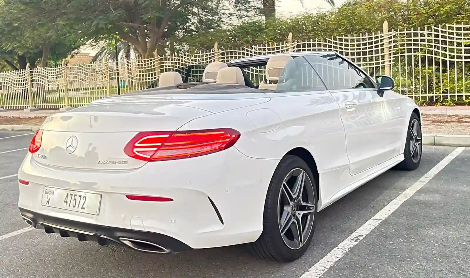 Side view of a shiny Mercedes C300 Convertible, perfect for cruising in Dubai's luxury districts.