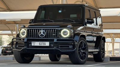 Luxury black Mercedes G63 AMG parked, ready for rent in Dubai - side view showcasing its elegant design.