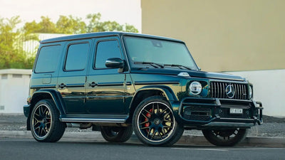 Luxurious black Mercedes G63 SUV parked on Dubai street, showcasing its iconic design and style, perfect for upscale rental.