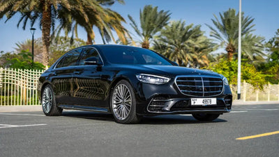 Luxurious black Mercedes S500 Executive Sedan parked on Dubai street, ready for rent.