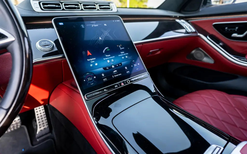 Side profile of the sophisticated Mercedes S500 Executive Sedan against Dubai skyline, for luxury rental.