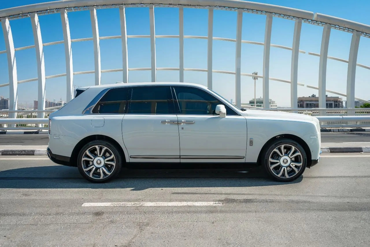 Side profile of a sleek Rolls Royce Cullinan, showcasing its distinctive lines and curves, perfect for luxury SUV rentals in Dubai.