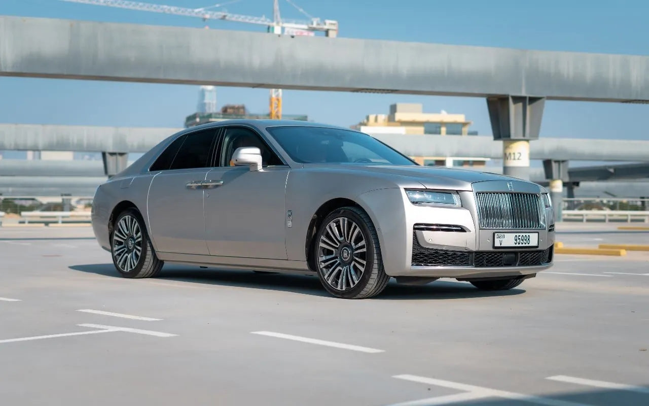 Elegant white Rolls Royce Ghost, 2022 model, parked in Dubai - luxury sedan rental option.