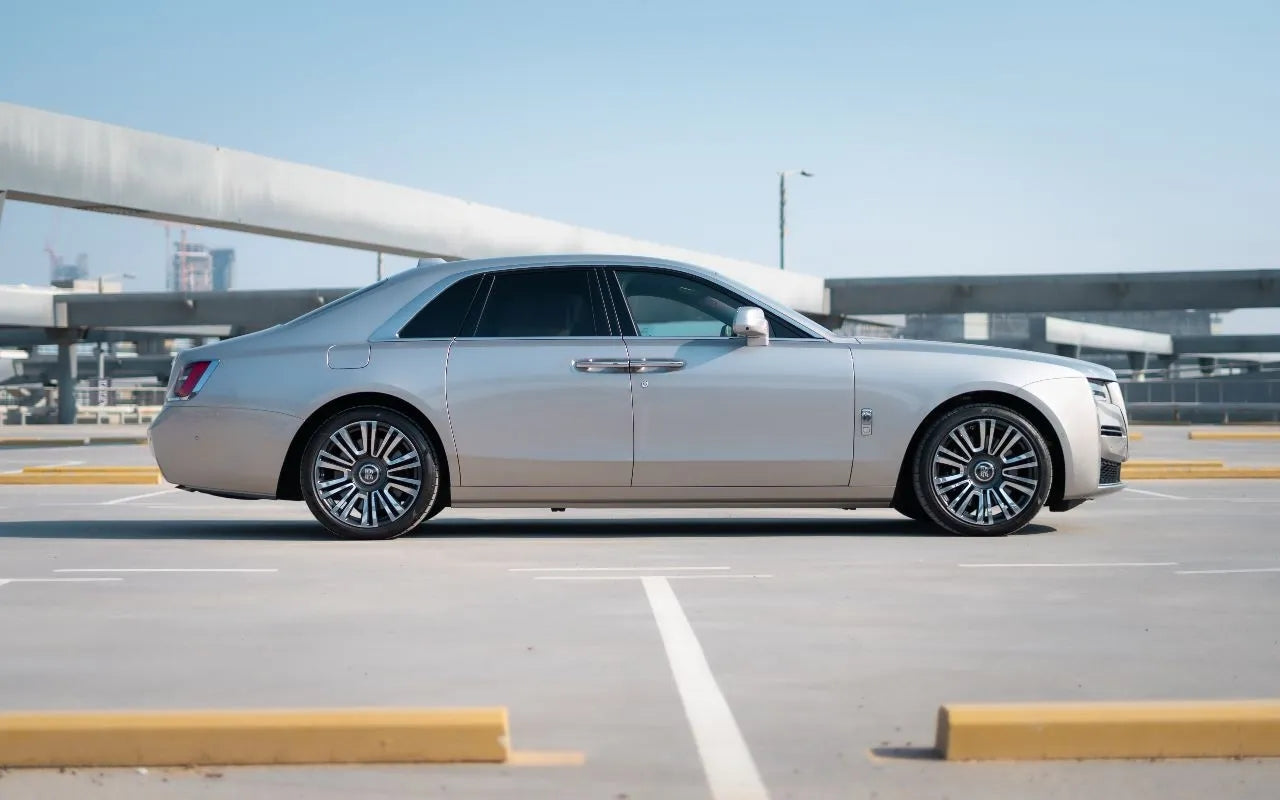 Front view of a sleek black Rolls Royce Ghost, perfect for VIP car rentals in Dubai.