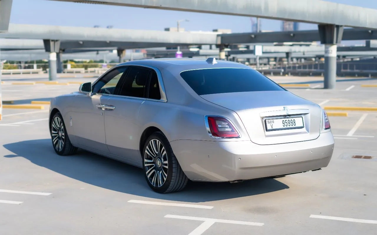 Close-up of the Rolls Royce Ghost's distinctive grille and emblem - symbol of luxury car hire in Dubai.