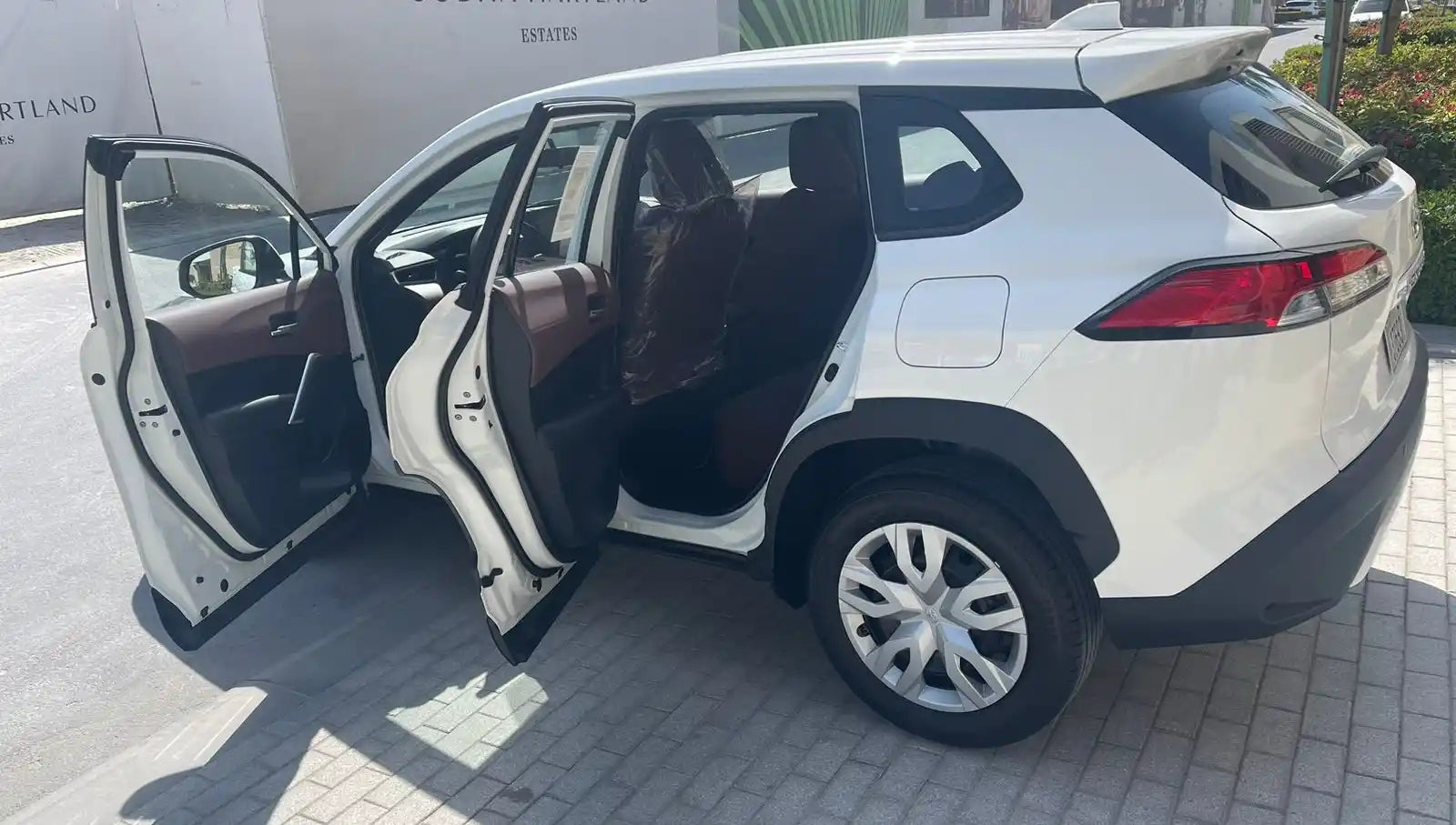 Toyota Corolla Cross parked in Dubai, showcasing its efficient economy car profile and stylish looks.