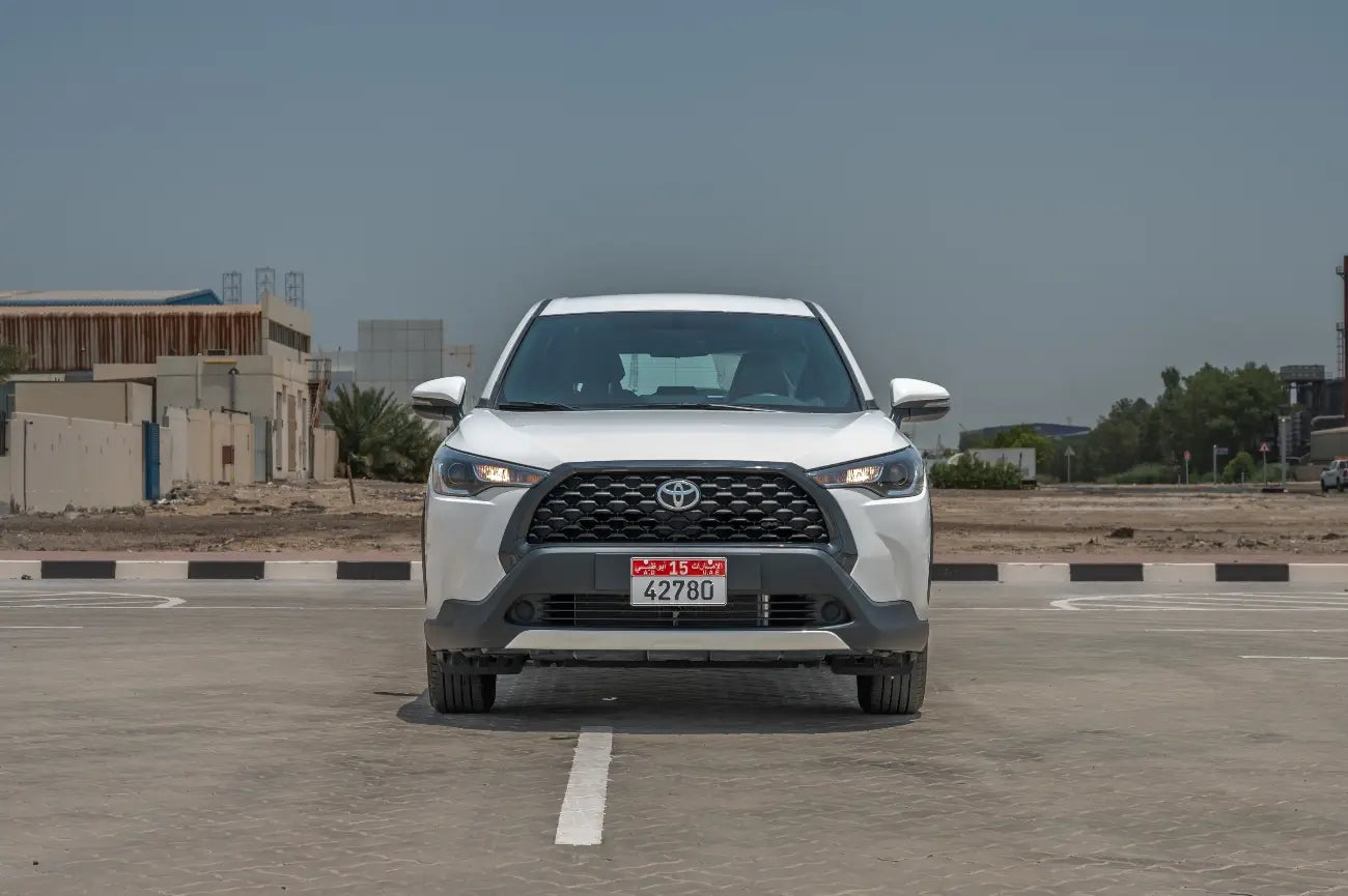 Side profile of the Toyota Corolla Cross rental in Dubai, highlighting its compact SUV shape and versatile economy class.