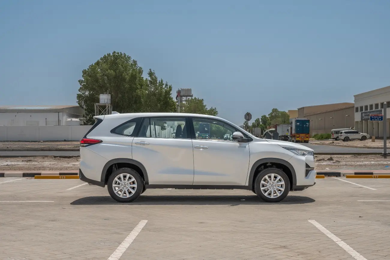 Toyota Innova Hybrid side view showcasing sleek design, top choice for van rental in Dubai