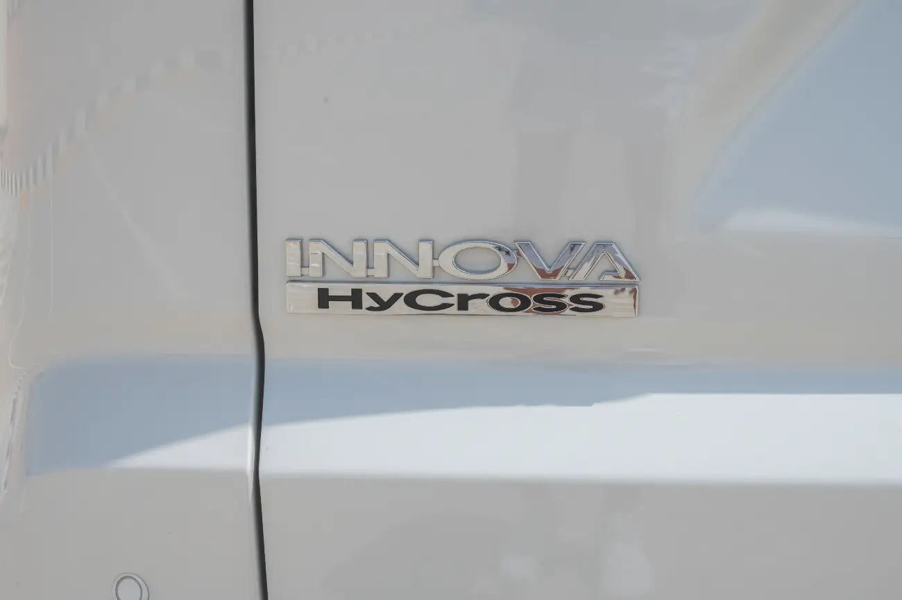 Driving action shot of Toyota Innova Hybrid on Dubai streets, best in class luxury van rental